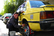 An Iraqi taxi driver washes his car with pride. Despite a war on Iraq, the locals manage to stay positive.