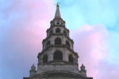 The gorgeous St Brides Church that is commonly used to locate Fleet Street on Londons skyline is seen here against a pink and blue sky on a sunny afternoon.